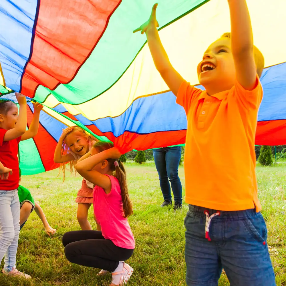 Kids playing under a parachute