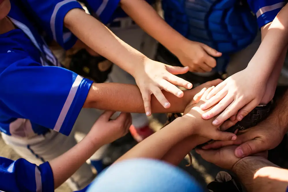 Team huddle with hands stacked together