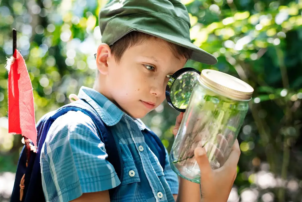 A camper looking at a plant in a jar